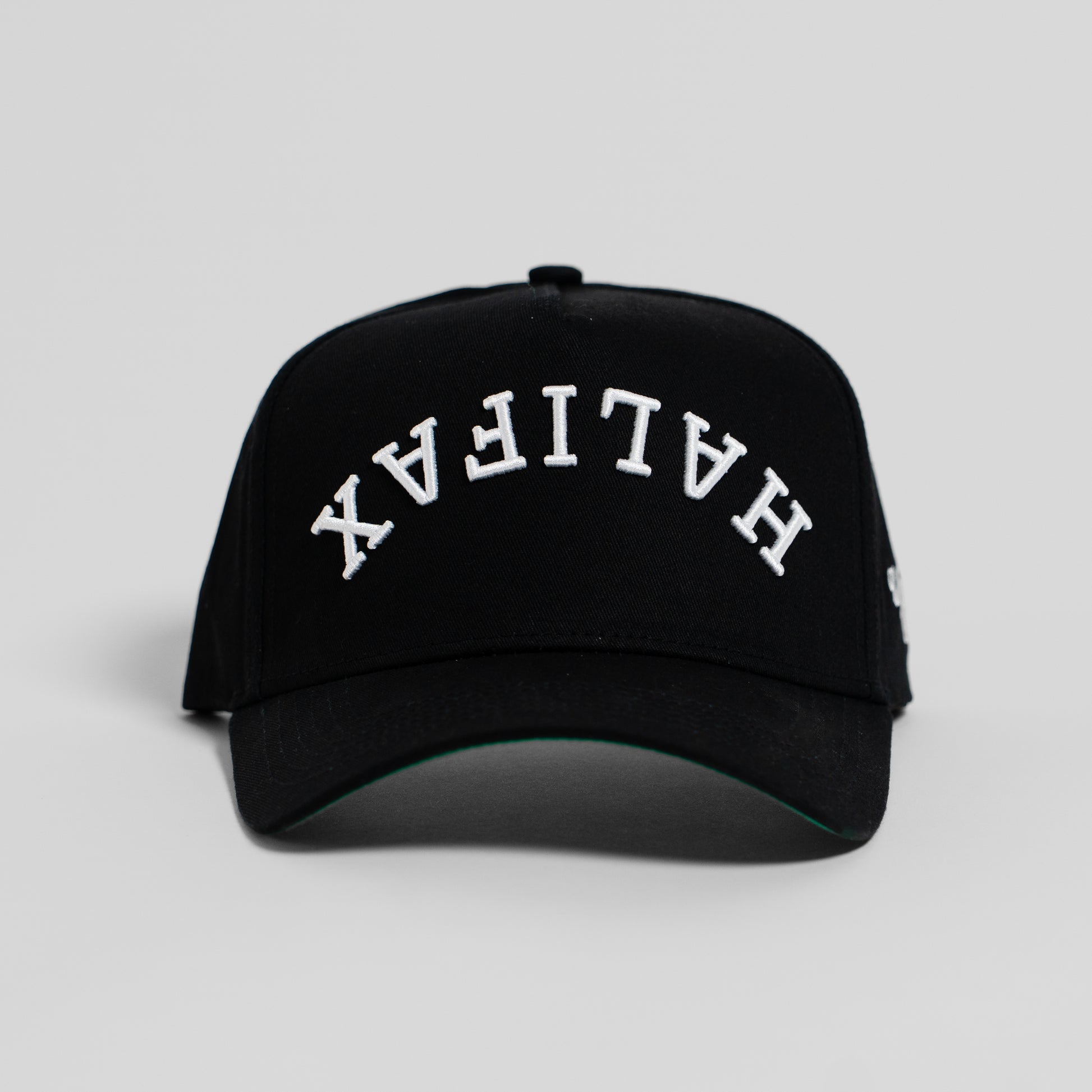 A black baseball cap with 'HALIFAX' embroidered in white arched letters on the front, shown against a light gray background.