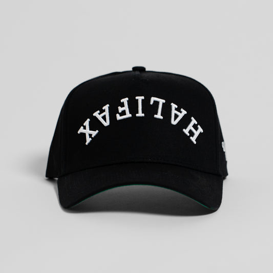 A black baseball cap with 'HALIFAX' embroidered in white arched letters on the front, shown against a light gray background.